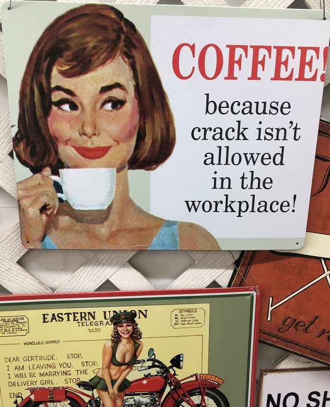 woman with brown hair drinking coffee tin sign